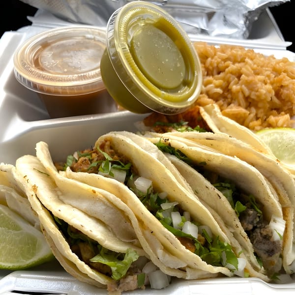 Five street tacos with cilantro, onions, and lime, served with rice and two sauces.
